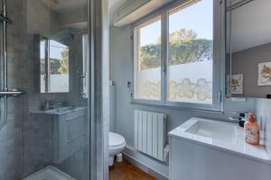 a bathroom with a sink and a toilet and a window at Maison Gecko - Proche de la plage in Cavalaire-sur-Mer +17 photos