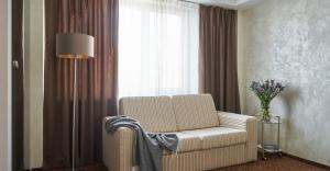 a living room with a chair and a window at Готель Дружба in Kyiv +72 photos