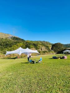 a white tent in the middle of a field at Lavender farm home in Port St. Johns +7 photos