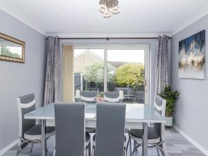 a dining room with a table and chairs and a window at Zadena in Bath
