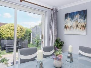 a living room with a table and a large window at Zadena in Bath