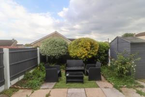 a yard with two chairs and a fence at Zadena in Bath +9 photos
