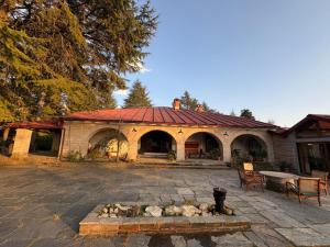 a building with a fire pit in front of it at Khali Estate in Binsar