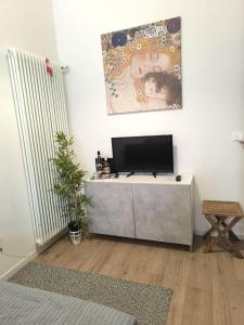 a living room with a flat screen tv on a table at KAIROS RESIDENCE in Parma