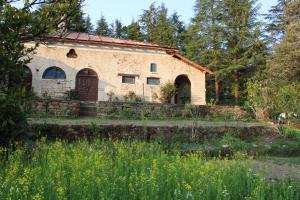 an old stone house with a garden in front of it at Khali Estate in Binsar +19 photos