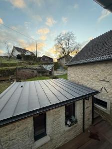 a roof of a building with a wooden deck at La Maison Dehlinger, chambres hôtelières et gîte in Gros-Réderching