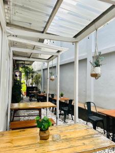 an outdoor patio with tables and chairs and a table with plants at Ministry Homestay in Yogyakarta