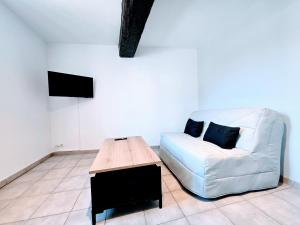 a living room with a couch and a coffee table at La Croix Duplex - Bail Partner in Chablis