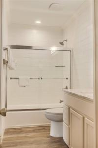 a white bathroom with a toilet and a sink at 10 A, One Bedroom Condo in Destin +15 photos