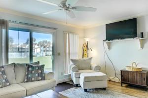 a living room with a couch and a chair and a tv at 10 A, One Bedroom Condo in Destin