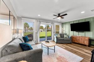 a living room with a couch and a flat screen tv at C' Salt 10B in Destin