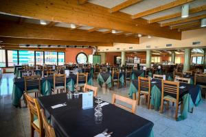 a dining room with tables and chairs in it at Hostal Los Infantes in Olvega +16 photos