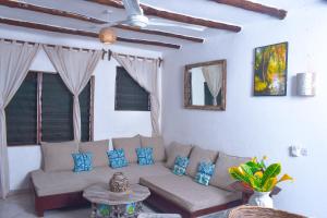 a living room with a couch and a table at Horizon Bavaria Villa in Mtwapa