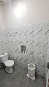 a bathroom with a toilet and a bidet at Z Guest House in Banyuwangi
