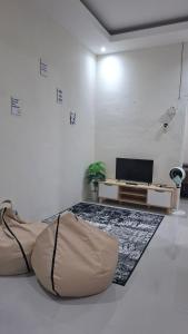 a living room with a bean bag chair and a television at Z Guest House in Banyuwangi