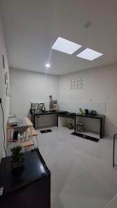 a large white room with a table and a ceiling at Z Guest House in Banyuwangi