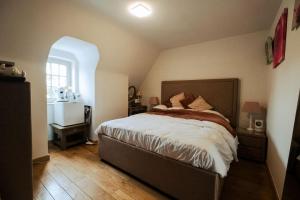 a bedroom with a large bed in a room at Rozerie BV in Waregem +9 photos
