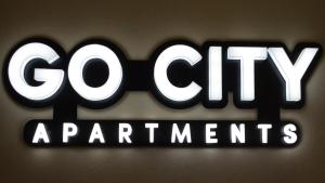 a sign that says go cityagents on a wall at GoCity apartments in Volos