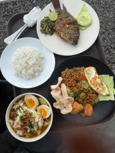 three plates of food on a table with rice and meat at Uma Danu Villas Kintamani in Kubupenlokan
