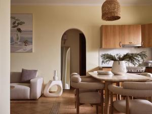 a kitchen and living room with a table and chairs at Ilision - Contemporary Living Residences in Argassi