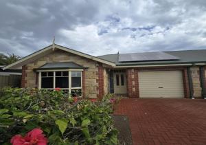a brick house with a garage with a solar roof at The Prospect Executive Home in Prospect