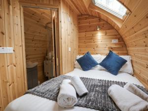 a bedroom with a bed in a wooden cabin at Oak View in Rhayader