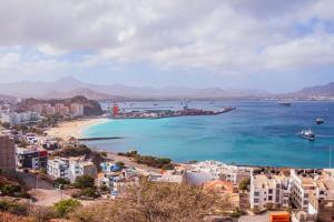 a view of a beach with buildings and the ocean at Avenida Dr Baltazar Lopes da Silva 33A in Mindelo