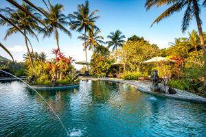 a pool at a resort with a dog in the middle at Villa Taman di Blayu by AGATA in Tabanan