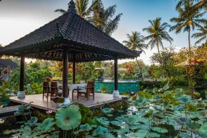 a garden with a pavilion and a pond with lilies at Villa Taman di Blayu by AGATA in Tabanan +43 photos