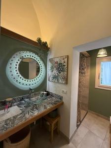 a bathroom with a sink and a mirror at Tati's Home CHARME & BIKERS in Mandello del Lario +43 photos