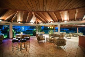 a patio with chairs and tables and a couch at Delta Resort Apartments in Ascona