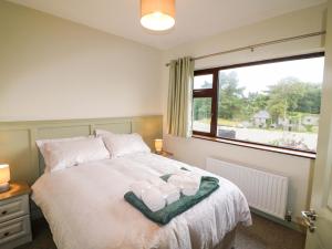 a bedroom with a bed and a large window at Shamrock House in Killorglin
