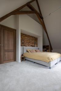 a bedroom with a large bed and a brick wall at Park Lofts Groningen in Groningen +34 photos