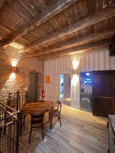 a dining room with a wooden table and chairs at Emme Loft I Sweet Moon - Exclusive Loft & Private Spa Milan in Milan