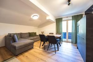 a living room with a couch and a table at Schusterhäusl in Rauris