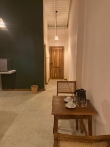 a room with a table and chairs and a hallway at Sea Station in Habaraduwa Central
