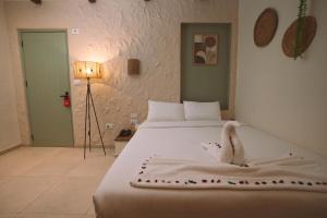 a bedroom with a bed with a stuffed animal on it at Voyage On The Spot in Cairo