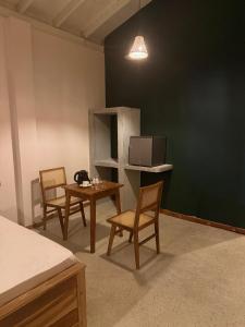 a room with two chairs and a table with a television at Sea Station in Habaraduwa Central