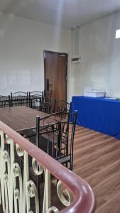 a room with chairs and a table with a blue counter at HOM's HOSTEL in Phuket