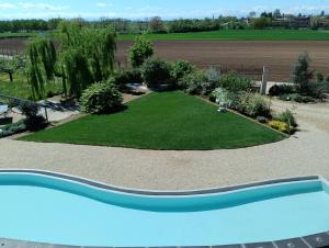a garden with a pool in the middle of a yard at Florario B&B in Chieri