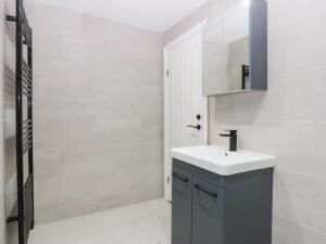 a bathroom with a sink and a mirror at Chandlers Cottage in Conwy +16 photos