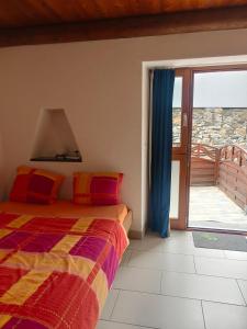 a bedroom with a bed and a sliding glass door at Garni Rosa Delle Alpi in Gordola