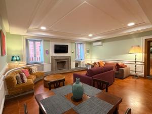 a living room with a couch and a table at HiSuiteROME - ApartHotel in Rome