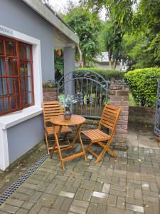 two chairs and a table on a patio at Roux Casa 2 in Swellendam
