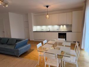 a living room with a table and a blue couch at Villa Diana WestEnd in Frankfurt