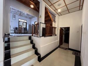 a hallway of a house with a staircase in it at Social Stay Hostal in Ahangama