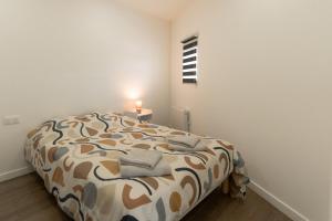 a bedroom with a bed in a white room at 201- Appartement- proche gare in Saint-Brieuc