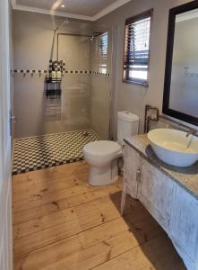 a bathroom with a toilet and a sink at The Lekker Plek - Private country cottage in Zuurbraak +16 photos
