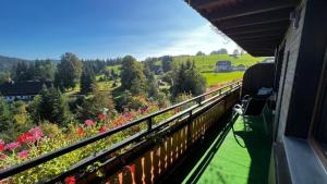 a balcony of a house with a view of flowers at Boutique Hotel & Apartments Pension Sternen in Todtmoos