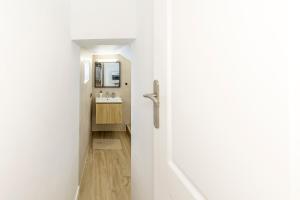 a door leading to a bathroom with a sink at Charming Street Studio in Tegueste in Santa Cruz de Tenerife